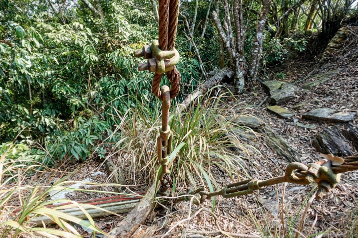 Rusted anchor cables going into ground